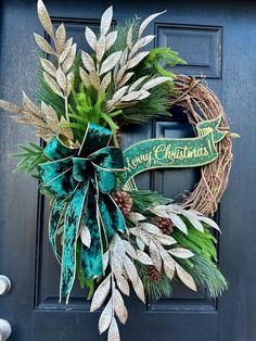 a christmas wreath on the front door with evergreen leaves and pineconi in it