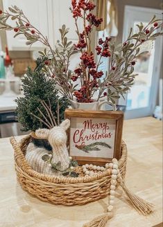 a basket filled with christmas decorations sitting on top of a table next to a sign