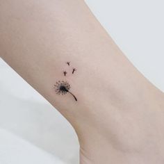 a small dandelion tattoo on the ankle