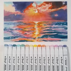 the watercolors are lined up and ready to be used in this painting project