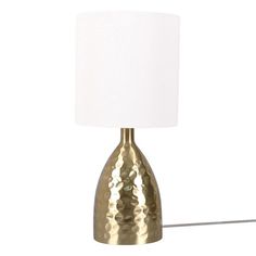 a gold lamp with a white shade on it