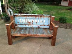 an old wooden bench with the word cheuprolet painted on it's back