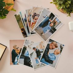 several polaroid photos on a table next to a coffee cup and plant with potted plants