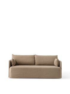 a beige couch sitting on top of a white floor