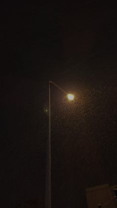 a street light on a pole in the dark