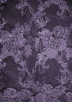 the fabric is purple and has white flowers on it, as well as lace trims