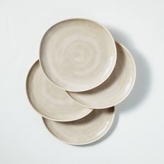 three white plates stacked on top of each other