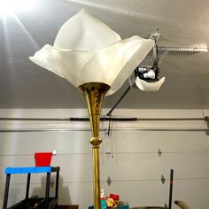 a lamp that is sitting on top of a table next to boxes and other items