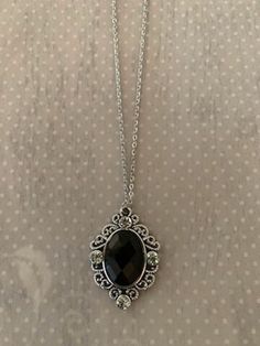 "This rich and sophisticated oval shaped necklace in tibetan silver and black has an intricately designed edging with a black crystal center stone and 4 rhinestone accents.  Pendant measures 1 3/8\" L X 1\" W and is on an 18\" chain.    ★ Want to see more?  Please visit my shop at: https://www.etsy.com/shop/DesignsByPeg" Black Jewelry Necklace Stone, Necklace With Black Stone, Black Gem Jewelry, Silver Necklace With Black Stone, Necklace Black, Black Necklace Aesthetic, Black Gem Necklace, Necklace Crystal, Black Stone Pendant