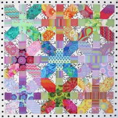 a colorful quilt with many different designs on it