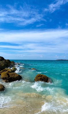 the water is crystal blue and clear with some rocks in it's foreground