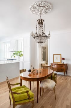 a dining room table with chairs and a chandelier