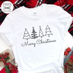 a white t - shirt with merry christmas trees on it