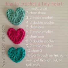 three crocheted hearts sitting on top of a piece of paper with instructions for how to crochet a tiny heart