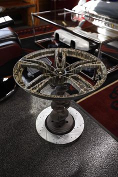 a glass table with wheels on it in the middle of a room filled with furniture