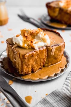 a piece of cake on a plate with whipped cream and caramel sauce around it