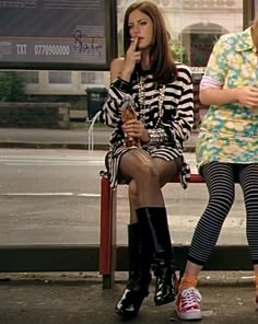 two women sitting on a bench talking to each other