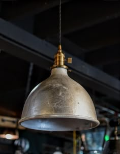 an old metal light hanging from a ceiling