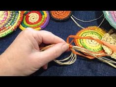 a person is making baskets with yarn and scissors