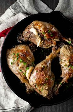 chicken in a skillet with parsley on the side