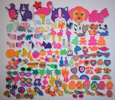 a bunch of different colored stickers on a white surface with one being cut out to look like animals