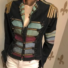 a mannequin wearing a jacket with multicolored stripes and gold trims