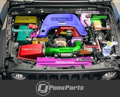 the engine compartment of a car with colorful parts