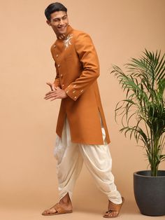 SHRESTHA By VASTRAMAY Men's Mustard Pearl Embroidered Indo With Dhoti Set Elevate your traditional wardrobe with the SHRESTHA By VASTRAMAY Men's Mustard Pearl Embroidered Indo With Dhoti Set. This exquisite ensemble combines classic design with contemporary elegance, making it perfect for festive occasions and cultural celebrations. The intricate pearl embroidery adds a touch of sophistication and charm. Features Mustard color with pearl embroidery Includes an Indo-Western kurta and dhoti set Comfortable fit for all-day wear Perfect for traditional and festive occasions Elegant and sophisticated design Specifications Brand: SHRESTHA By VASTRAMAY Color: Mustard Embroidery: Pearl Set: Indo-Western kurta and dhoti Occasion: Festive, Traditional Fit: Regular Material & Care Material: Premium f Traditional Wardrobe, Mens Traditional Wear, Wedding Dresses Men Indian, Mens Sherwani, Men's Ethnic Wear, Cream Silk