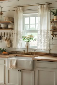 a kitchen sink sitting under a window next to a counter