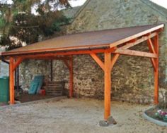 an old stone building with a wooden roof