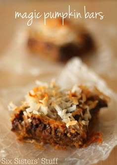 two pieces of food sitting on top of plastic wrapper next to each other with the words magic pumpkin bars written above them