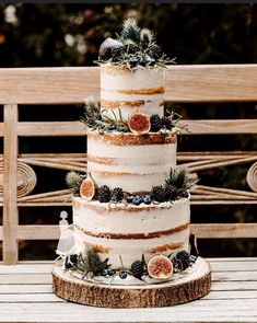 a three tiered cake with figurines on top