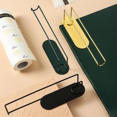 various office supplies are arranged on a table top, including a roll of paper and scissors