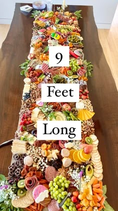 a long table covered in lots of different types of food on top of each other