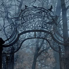 an iron gate with the words nevermore again written on it in front of trees