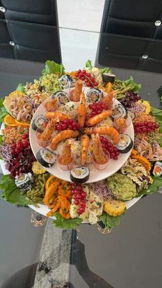 a platter filled with lots of food on top of a table