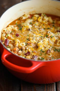 one pot chili macaroni and cheese in a red casserole dish on a wooden table