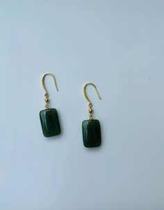 A pair of elegant rectangle-shaped dark green jade cube earrings with 14k gold ear wire. They are made from high-quality real Chinese jade and 925 sterling silver plated with 14k gold. Simple and minimalistic design works great for all sorts of occasions: dating, daily wear, home or office, you name it. Perfect as a gift for your loved ones or yourself. Highlights: ♥ High-quality materials Hand-made with quality dark green jade, paired with 925 sterling silver plated with 14k gold. Ensure long last wear and they are friendly for sensitive skin. ♥ Simple and minimalistic design Great for all sorts of occasions and perfect for gifting  ♥ Measurements Each drop is measured 1.5cm diameter and 2.5cm long. ♥ 100% Satisfaction Guarantee Gift-worthy packaging included! Please include a message if Cheap Green Minimalist Jewelry, Cheap Green Danglers Perfect As Gifts, Cheap Bohemian Green Earrings, Handmade Jade Earrings, Affordable Handmade Jade Earrings, Affordable Jade Bead Earrings, Cheap Everyday Green Earrings, Elegant Green Rectangular Earrings, Green Rectangular Earrings For Formal Occasions