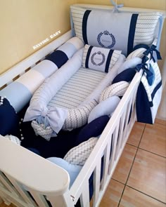 a baby crib with blue and white bedding