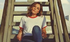 a woman sitting on top of a metal step