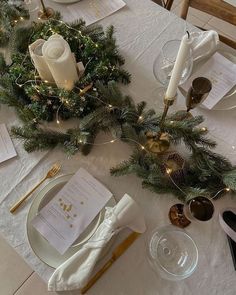 the table is set with candles, napkins and place settings for an elegant dinner