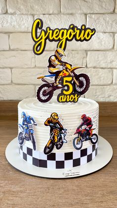 a birthday cake with the number five on it and three motorcyclist figures