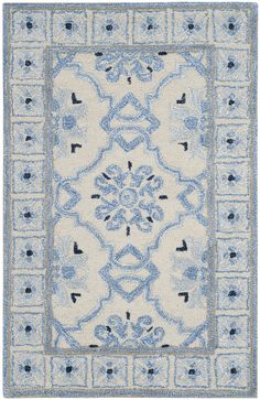 a blue and white rug with an intricate design on the center, in front of a white background