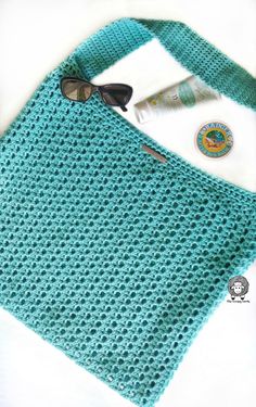 a crocheted bag with sunglasses and other items