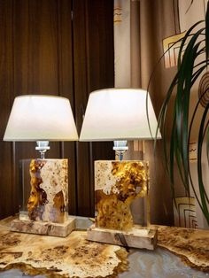 two lamps sitting on top of a wooden table