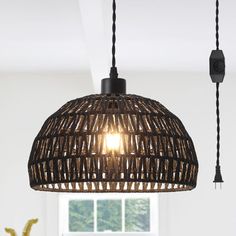 a light that is hanging from a ceiling in a room with white walls and flooring