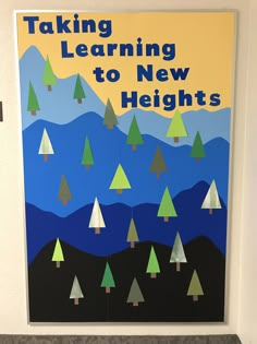 a poster on the wall that says taking learning to new heights with trees and mountains