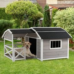 a dog is sitting in his kennel outside