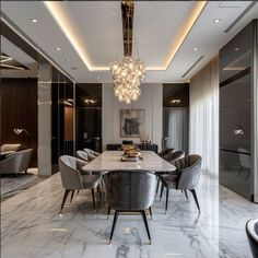 an elegant dining room with marble flooring and chandelier hanging from the ceiling