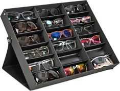 PRICES MAY VARY. SUNGLASSES DISPLAY STAND: This classy black sunglass case makes a statement while helping you store your favorite eyeglasses in a secure place. This organizer holds 18 pairs of glasses in the available slots, and the cover of the case opens easily with a snap. The stand dimensions are 18.5 " L x 14.6" W x 2.4 " H. SAFE STORAGE COMPARTMENT: The design of this case creates a great holder for your collection of fragile sunglasses and eyeglasses. Don't rely on a single, that only fits one pair at a time. Instead of leaving expensive eyewear to the mercy of thin foam or fabric sleeves, organize a large number of glasses or other delicate pieces out of sight until they are needed. MAKEUP & ACCESSORIES ORGANIZER: Don't have 18 different pairs of glasses? Use this display tray to Glasses Organization, Travel Display, Glasses Organizer, Glasses Display, Things Organized Neatly, Eyewear Display, Glasses Storage, Jewelry Tray Organizer, Wall Mount Jewelry Organizer